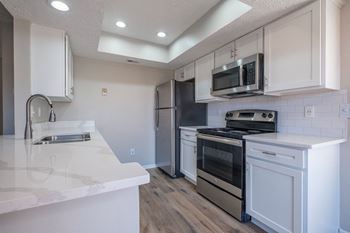 Stunning new kitchens with custom cabinetry and gleaming white granite countertops in select renovated homes! *